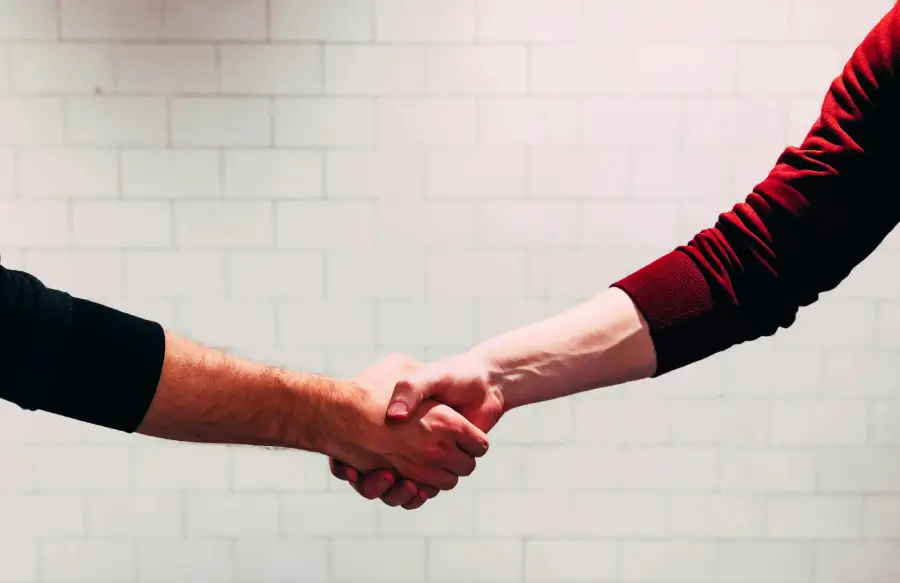 2 men shaking hands signifying the respect held in the Thrive Inside CIC Privacy Policy.